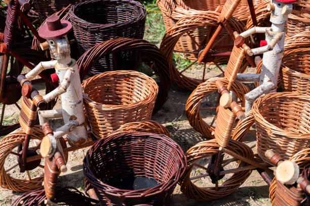 beautiful handmade wickerwork decoration - bicycles made of wicker with stick figure drivers which could serve as plant pots in your backyard