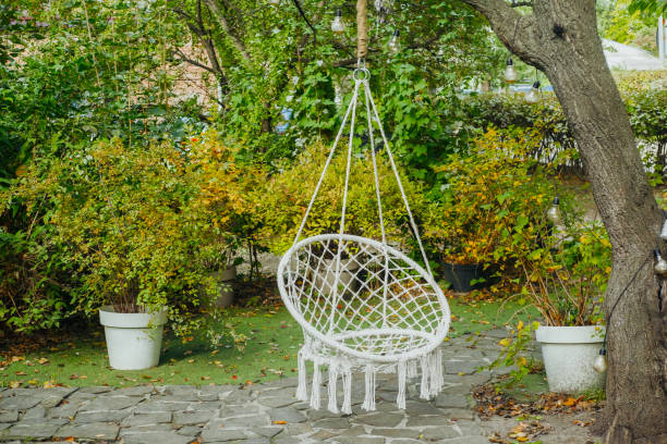 istock A cozy hanging chair in a lush garden surrounded by greenery 2180721425