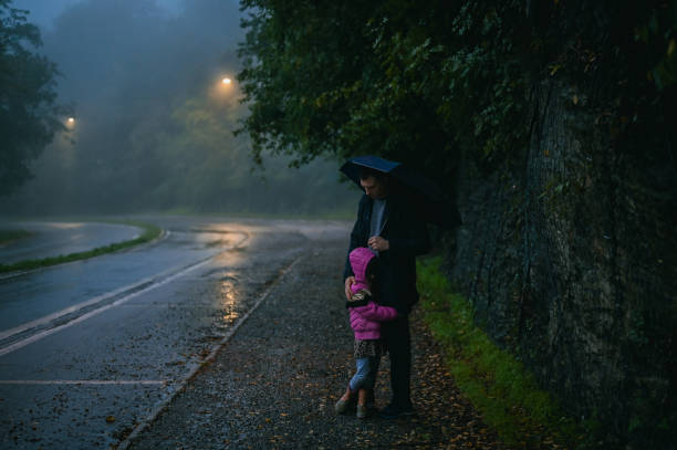 Father with cute daughter walking on empty street.