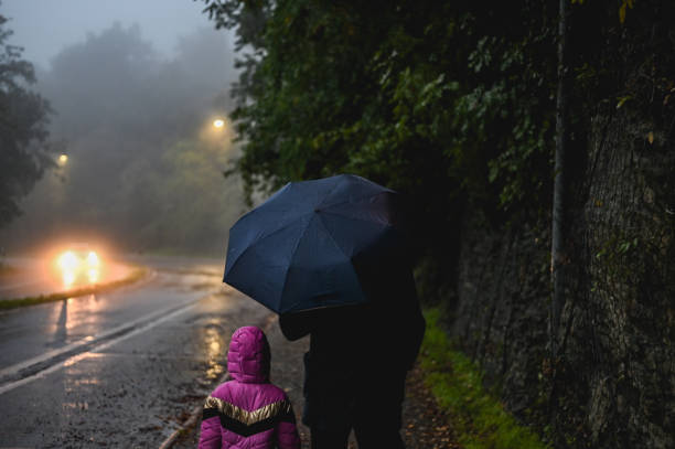 istock Family walking under the rain. 2180725386