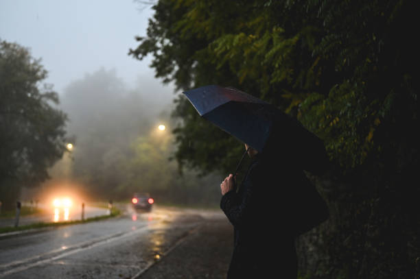 istock Man on a dark rainy street. 2180725390