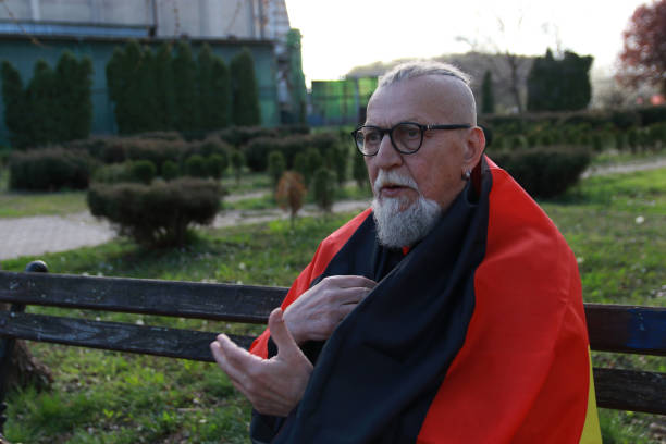 Taking a flag of Germany senior hipster modern bearded