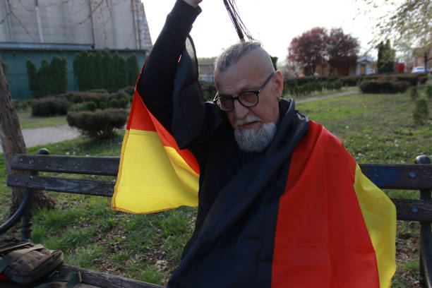 Taking a flag of Germany senior hipster modern bearded