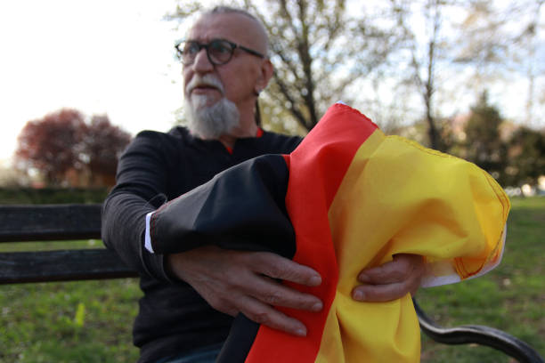 Taking a flag of Germany senior hipster modern bearded