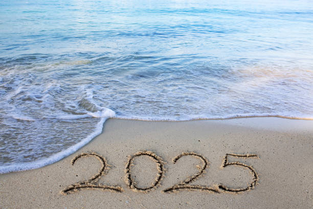 istock 2025 hand written in sand on a beautiful beach 2180731640