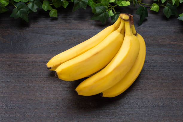 istock Fresh bananas on wooden table 2180732669