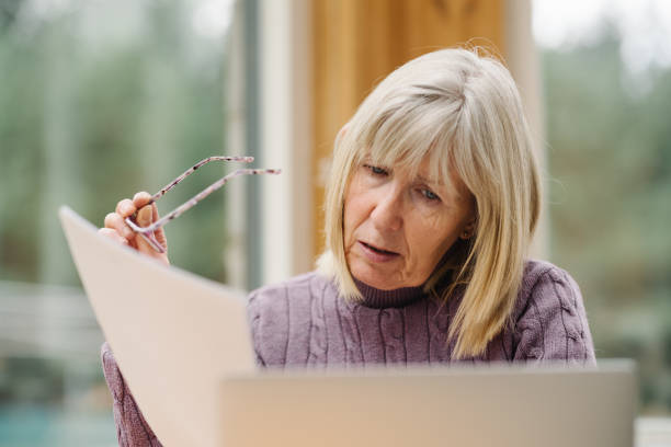 istock Worried senior woman just received a bill 2180736616