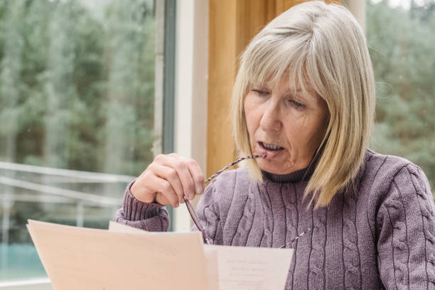 istock Worried senior woman just received a bill 2180736844