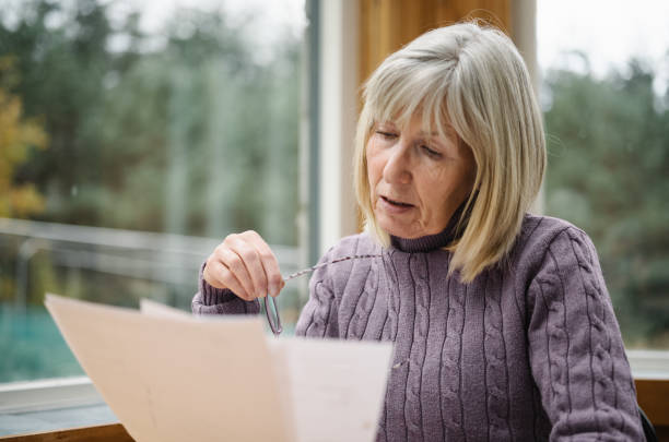 istock Worried senior woman just received a bill 2180737570