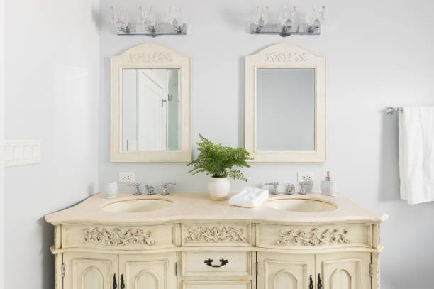 istock A bathroom with a cream colored cabinet and mirrors. 2180740534