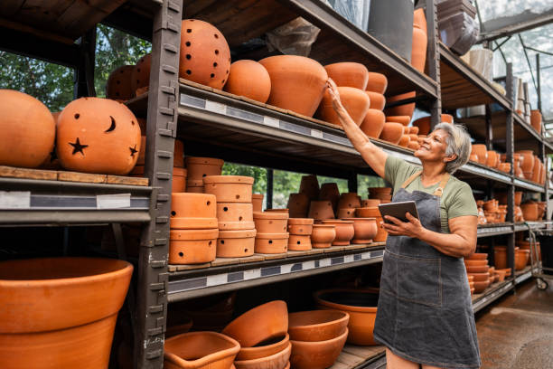 Senior saleswoman taking inventory using digital tablet at a garden center