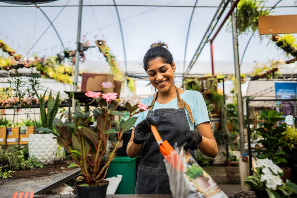 istock Young florist working at a garden center 2180743368