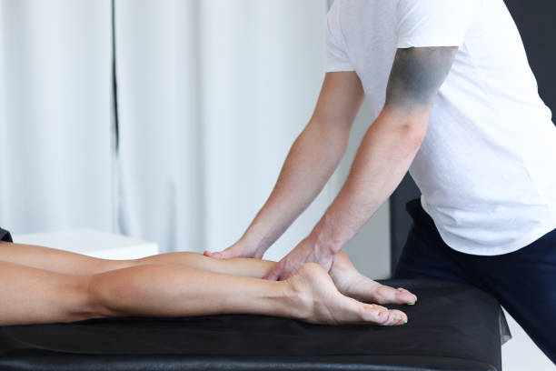istock Masseur does legs massage in spa center 2180747891