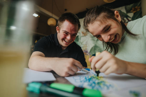 Two young friends enjoying a creative art session together in a cozy home setting.