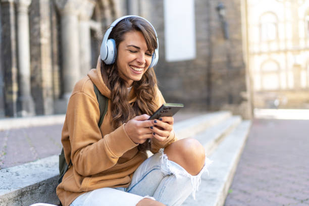 istock Young smiling woman using smartphone 2180755655