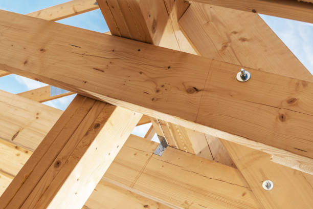 istock Construction of a Wooden Framework for a Building Under Clear Blue Skies in Daytime 2180756540
