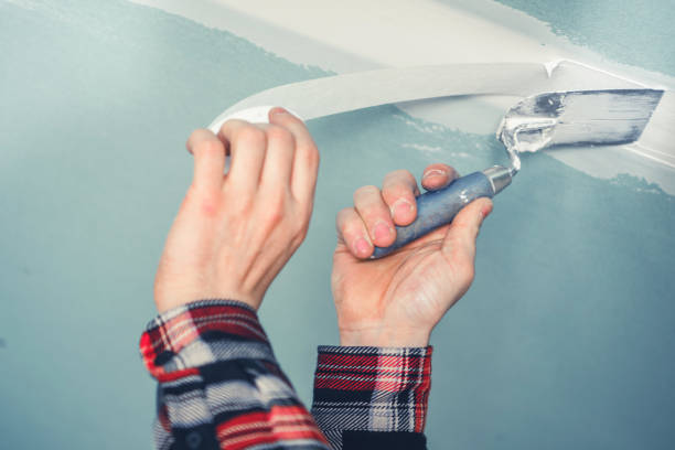 istock A Person Applying Patch to the Ceiling With a Roller in a Freshly Remodeled Room During Daytime 2180757155