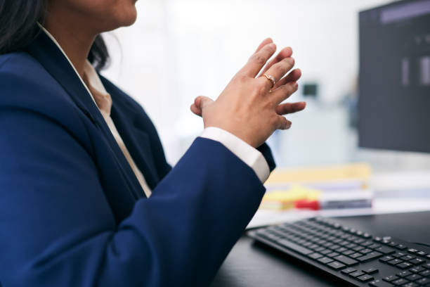 istock A close-up of hands making a gesture reveals a moment of pause while working at the computer desk, deep in thought. 2180757495