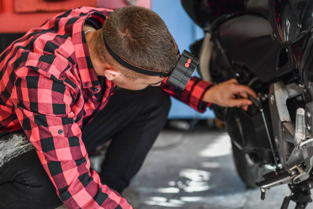 istock Dedicated Passionate Teenager Spending Time in Garage Working Examining and Improving His Motorcycle 2180762830