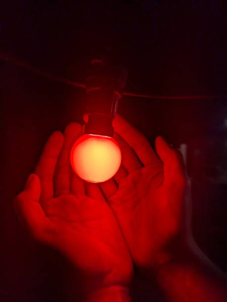 istock A Hand Holding A Red Lamp 2180763727