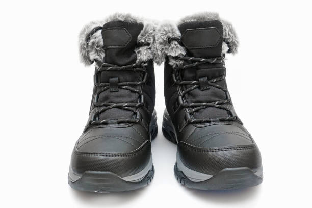 Warm winter leather waterproof ankle boots with fur inside, with laces on a white background