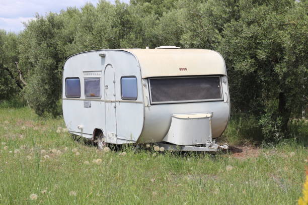 istock Caravan Parked in a Garden Surrounded by Olive Trees 2180775024