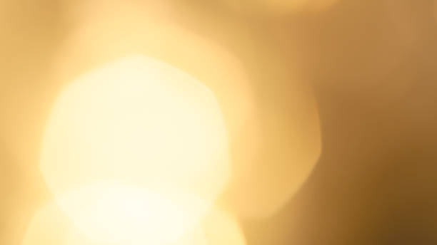 istock Soft golden bokeh lights with blurred circles on a warm gradient background 2180778201
