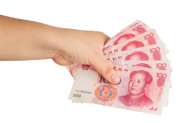 istock A hand holding a stack of Chinese yuan 2180778439