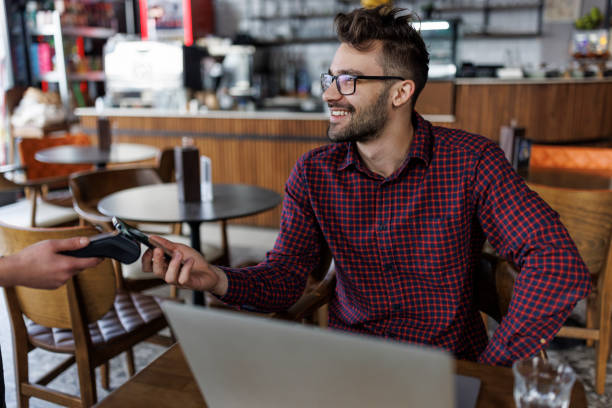 istock Young man paying for order at a cafe 2180779119