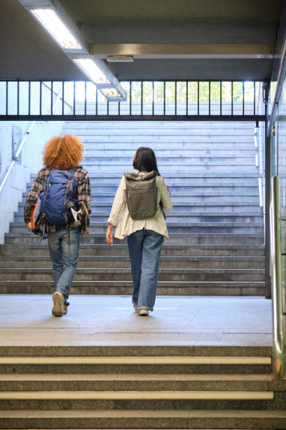 istock Students walking up stairs leaving subway station 2180783168