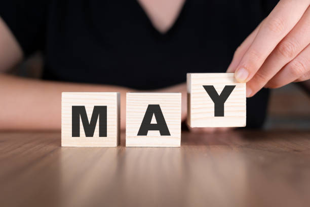 istock May word with wooden blocks on table 2180784760