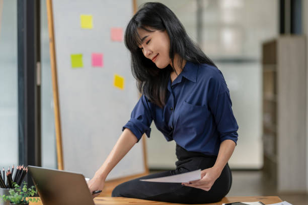 istock Young businesswoman checking documents in work area. 2180785166