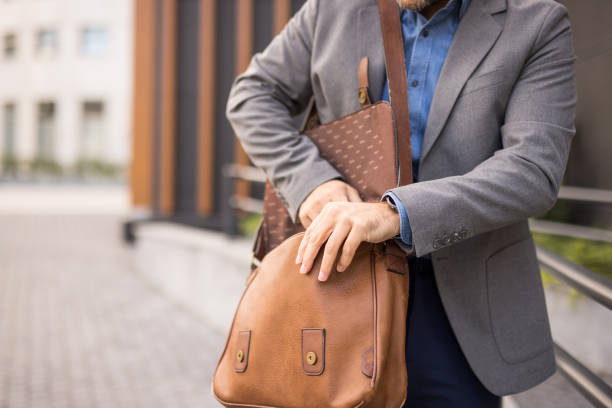 istock close up of a man's hand opening a bag 2180790984
