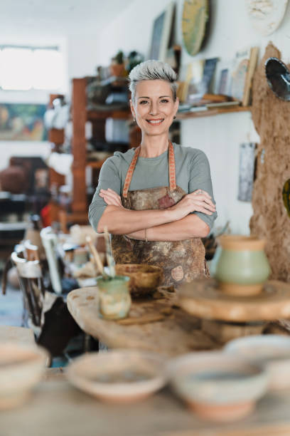 istock Smiling woman standing in a pottery workshop 2180791505
