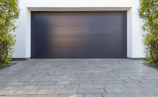 istock Modern Dark Garage Door with Paved Driveway 2180793755