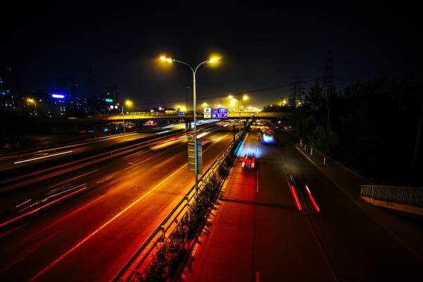istock Night view of an urban elevated expressway with traffic lights and trails 2180796777