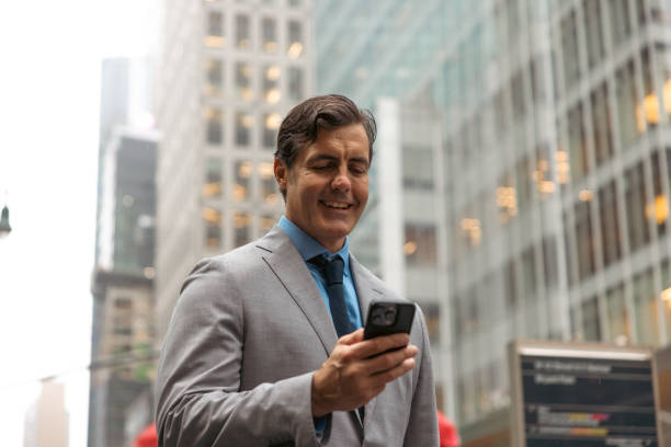 istock Businessman in Midtown Manhattan texting on mobile phone 2180797830