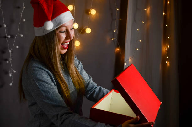 istock Happy woman opening a Christmas box 2180801366
