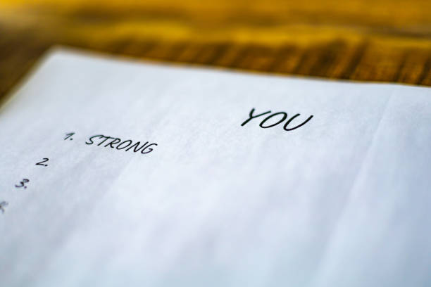 A Valentine's Day note with 'Te Amo' (I love You in Italian language) written in delicate handwriting, surrounded by colorful paper hearts and a lit candle, symbolizing love and expression through passion and creativity
