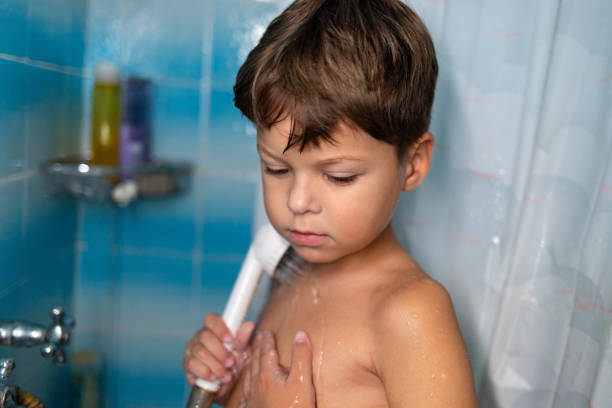 Above shot of a boy having fun diving in a bathtub full with clean water