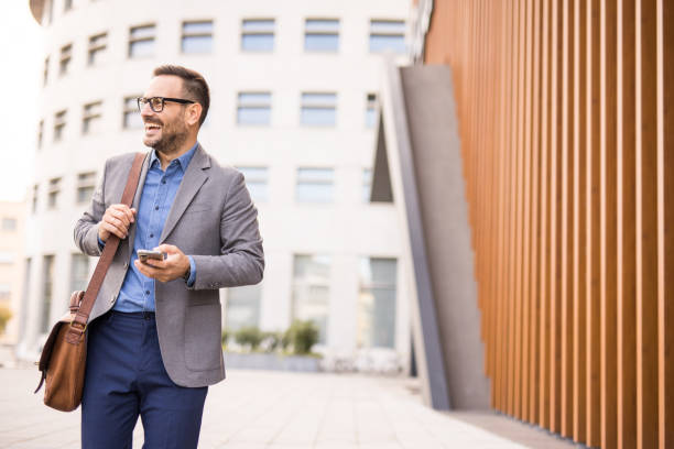 istock Good looking men use smartphone while going to work in the city. 2180805929