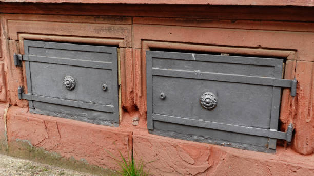 istock Vintage Access Doors in a Weathered Brick Wall With Decorative Hinges 2180808220
