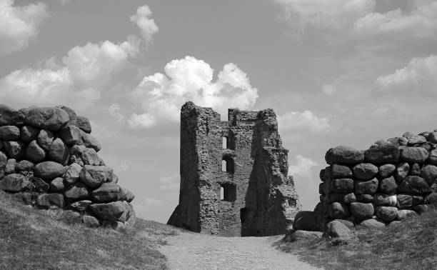 istock Ancient stone ruins stand against a cloudy sky at the historic site surrounded by large boulders and grassy pathways 2180813597