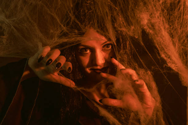Portrait of a young woman with an interesting make-up in the crop. She looks intensely and mysteriously at the viewer.