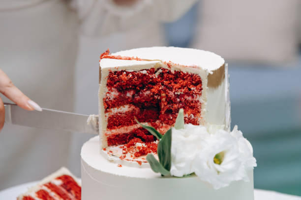 istock sliced white wedding cake with red sponge cake 2180814476