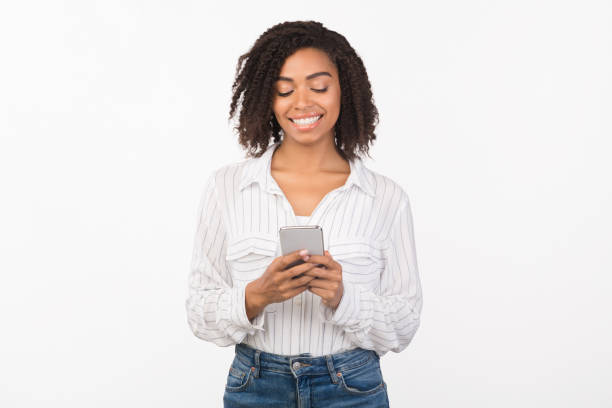 istock Smiling afro girl reading message from friend 2180815100