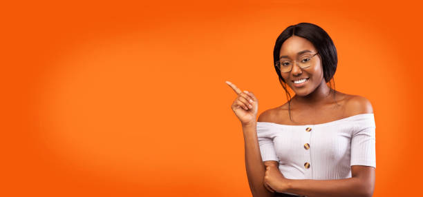 istock Afro Lady Pointing Finger Smiling Standing Over Orange Background, Panorama 2180816248