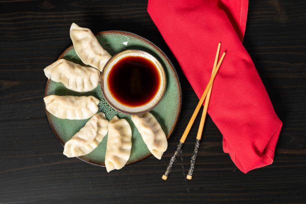 istock Pork potstickers and sauce with resting chop sticks 2180817345
