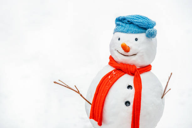 istock Snowman in a knitted hat and red scarf on a white background. 2180817453