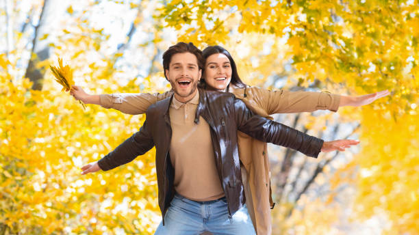 istock Emotional couple having good time in autumn forest 2180817476